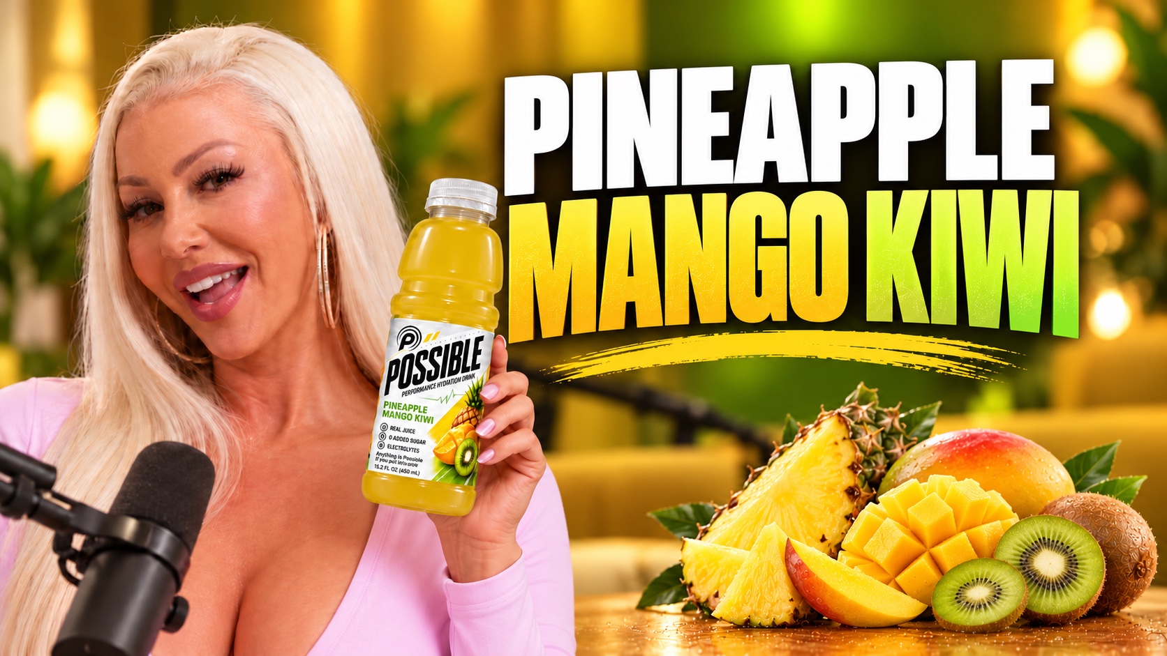 Woman holding a POSSIBLE Pineapple Mango Kiwi bottle beside a studio microphone with tropical fruit